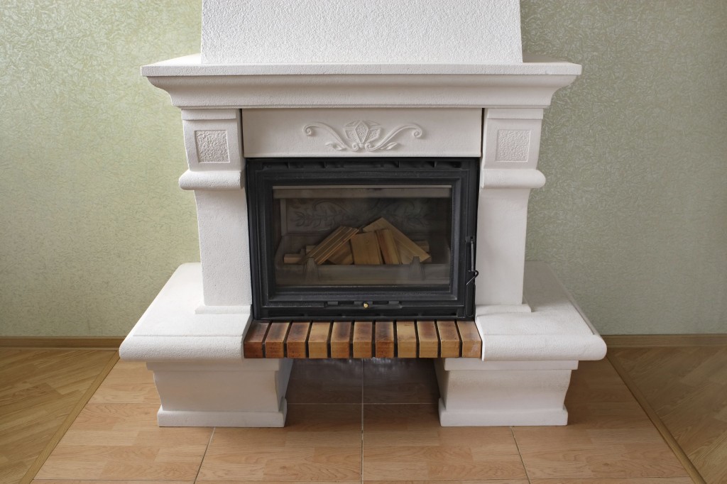 White unlit fireplace with logs