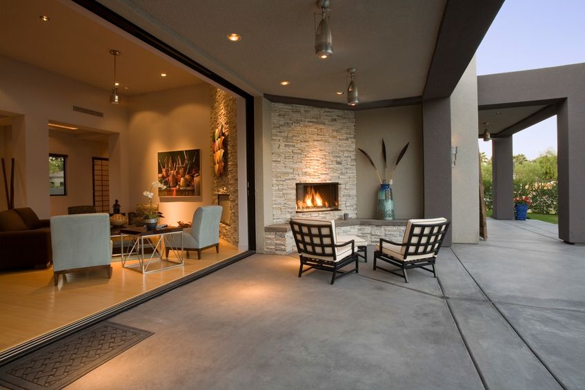 View of chairs by fireplace in patio of a modern home