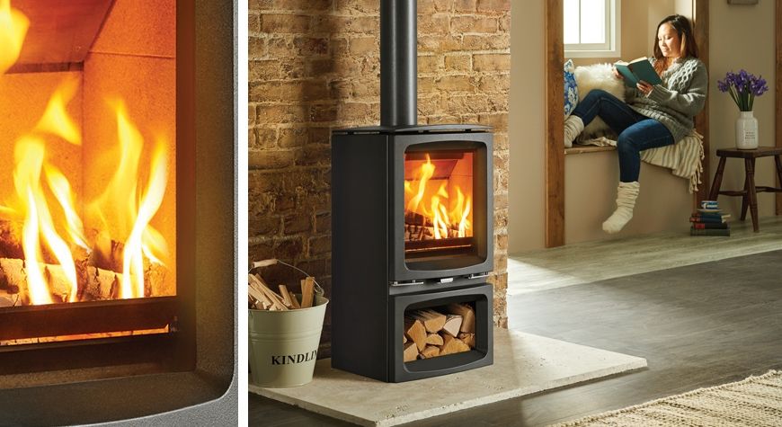 woman reading book in living room with wood burning stove