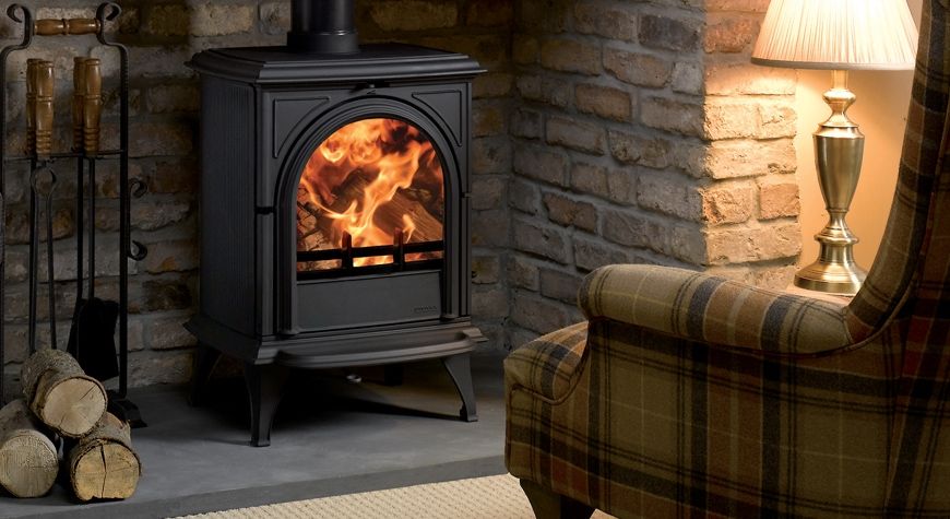 wood burning stove in living room in front of sofa