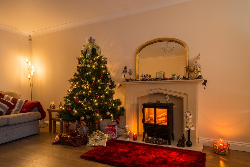 Warm glow of Christmas lights and a log burner in festive decoration