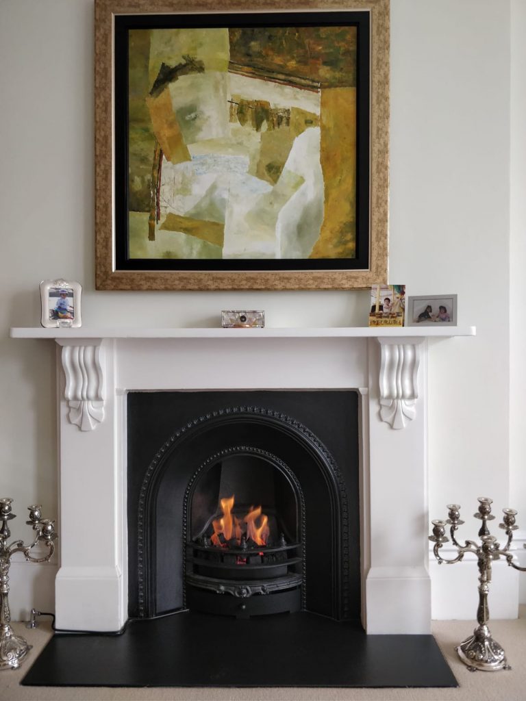 Fireplace with art hanging above