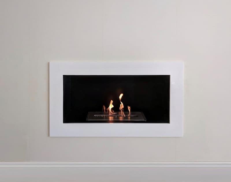 Contemporary wall mounted bioethanol fire on a white wall